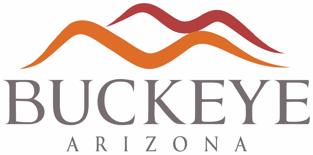 Logo for Buckeye, Arizona. The image features two stylized mountain shapes in orange and red above the words “BUCKEYE” in large gray letters and “ARIZONA” below in smaller gray letters.